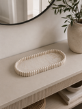 Aurea ribbed oval decorative tray styled on a modern neutral entryway console