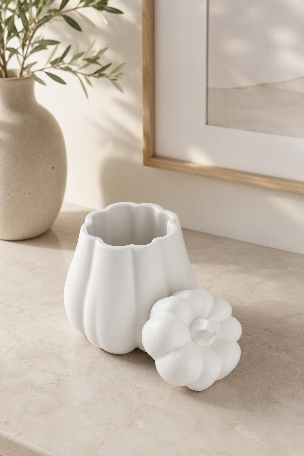 White pumpkin storage pot open with removable pumpkin lid beside it