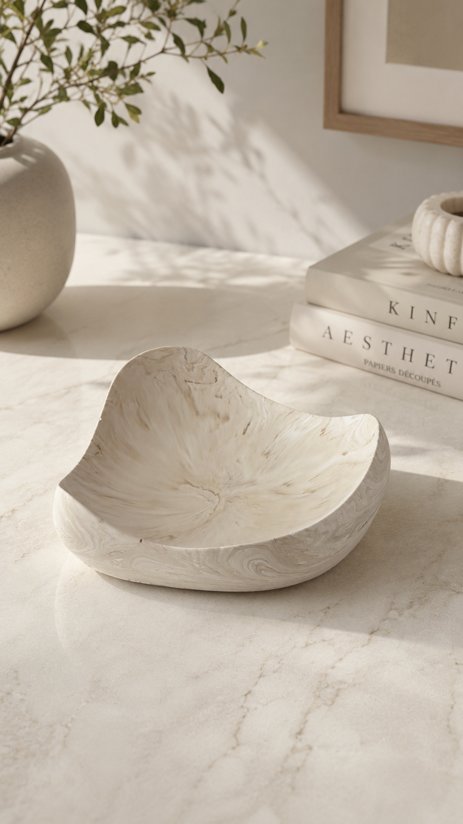 Luxe sculptural decorative bowl styled on a modern neutral entryway console