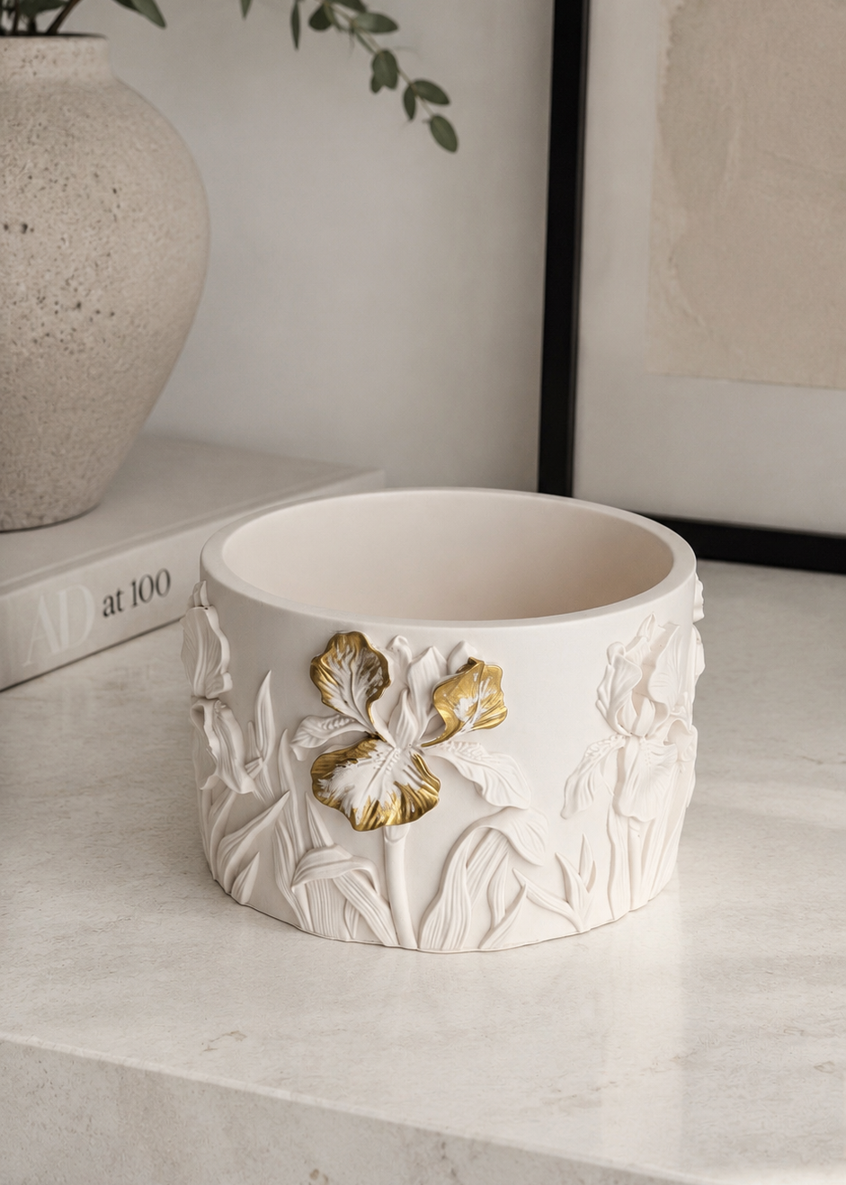 White Iris floral candle with gold flower detailing in a sculptural Jesmonite vessel
