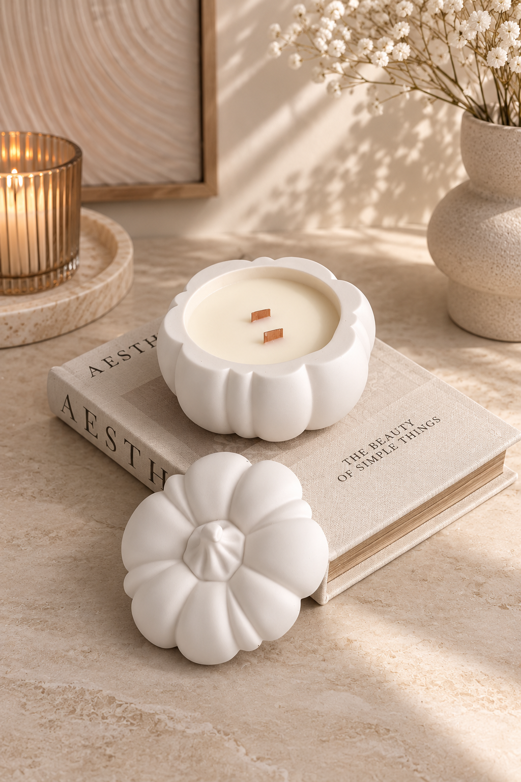 Pumpkin candle styled with elegant neutral autumn home decor