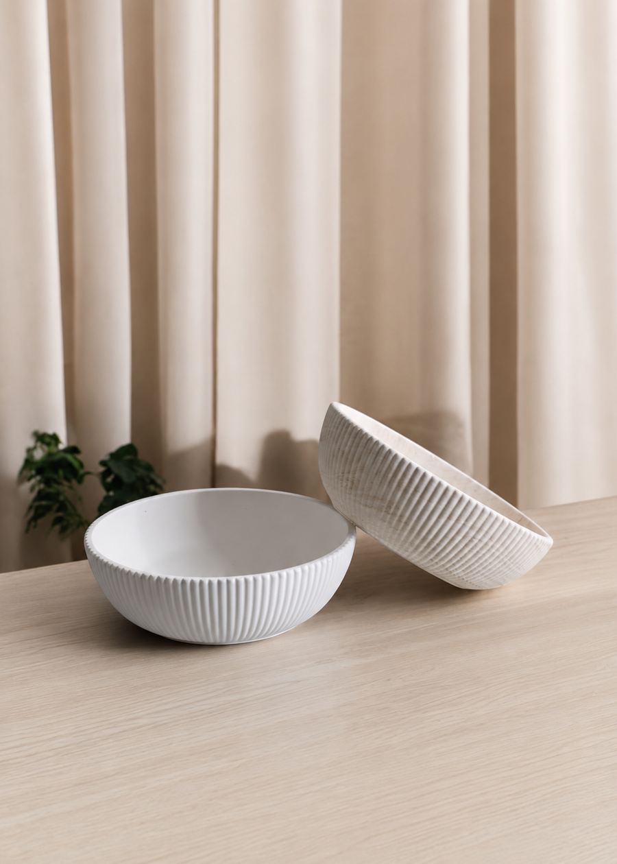 ribbed decorative bowl styled on a wooden table in a modern neutral interior