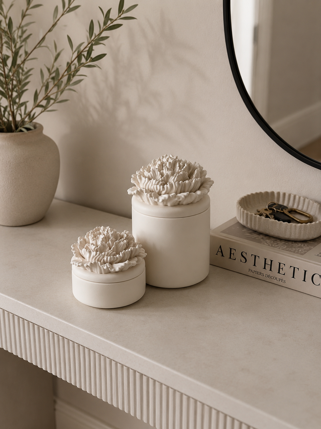 Handcrafted Jesmonite peony flower storage pot with removable floral lid styled on a modern neutral entryway console.