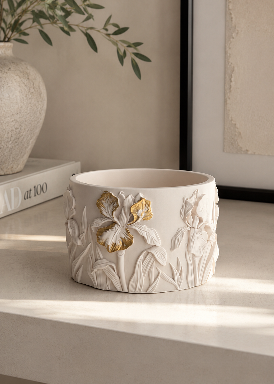 Iris Bloom decorative storage pot with raised iris flower and leaf details in a soft neutral finish.