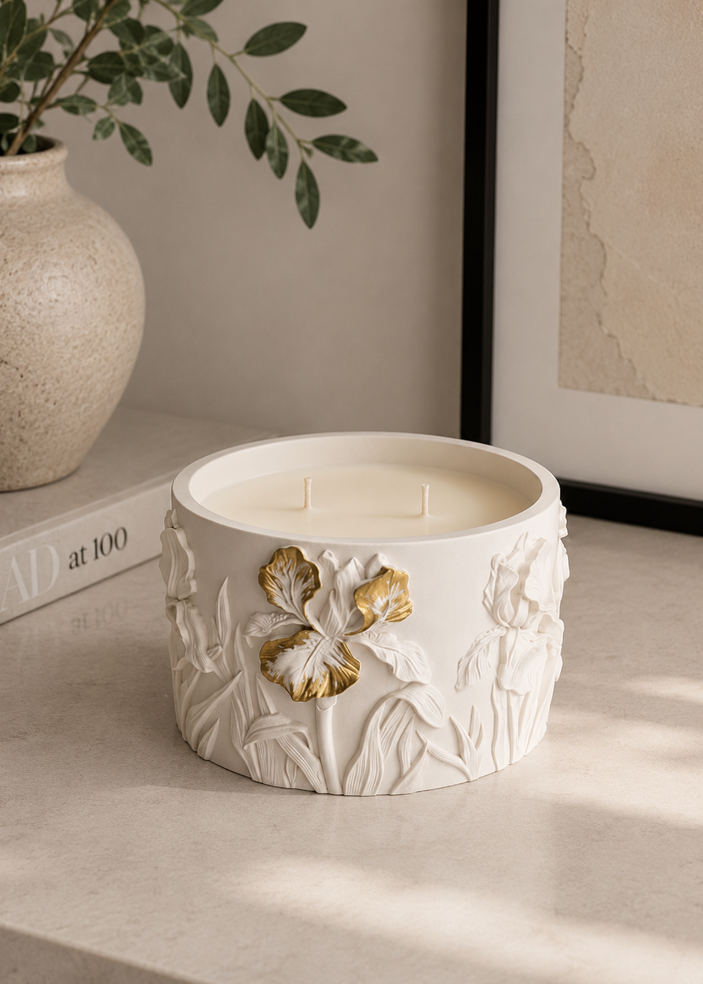 White Iris floral candle with gold flower detailing in a sculptural Jesmonite vessel