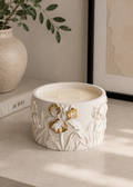White Iris floral candle with gold flower detailing in a sculptural Jesmonite vessel
