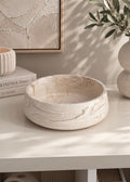 Solea sculptural decorative bowl in marble beige styled on a light oak console table with neutral flowers and modern home decor.