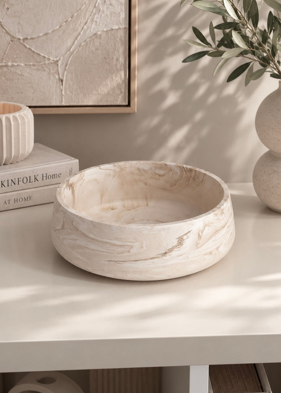 Solea sculptural decorative bowl in marble beige styled on a light oak console table with neutral flowers and modern home decor.